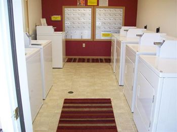 A laundromat with a red and white striped rug on the floor.